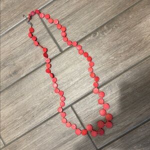 Long, salmon, wooden bead necklace.